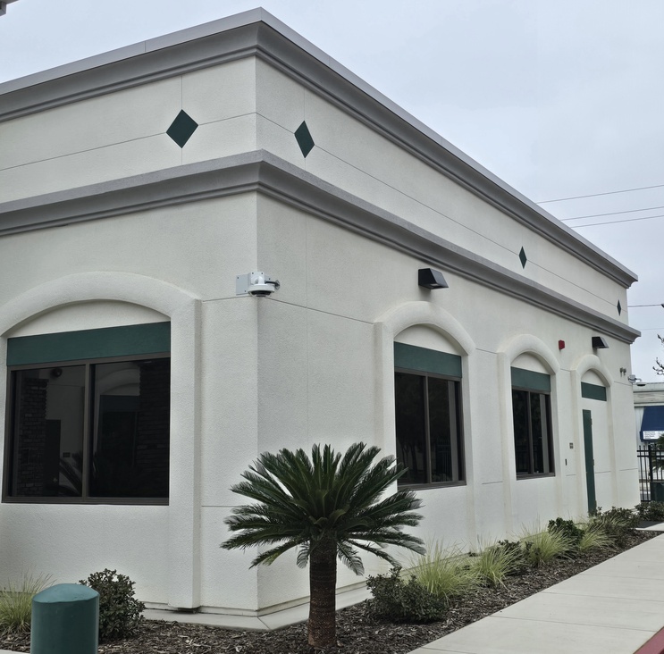 Exterior view of clean architectural stucco details and decorative cornices on a modern educational facility in Central California.