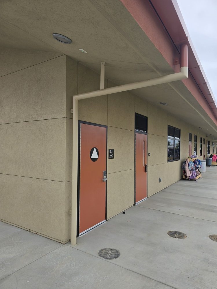 Side view of a school corridor showcasing flawless plastering and smooth soffit finishes for an educational facility.
