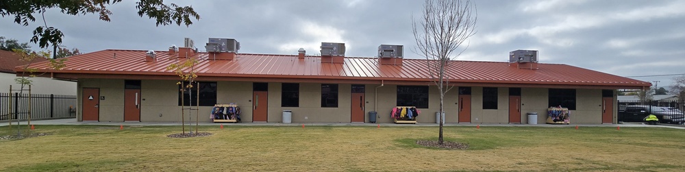 Wide exterior view of a kindergarten school building featuring durable stucco finishes designed to withstand high-traffic institutional use.