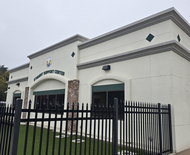Angled perspective of a school administration building featuring high-durability exterior plastering and clean trim work.